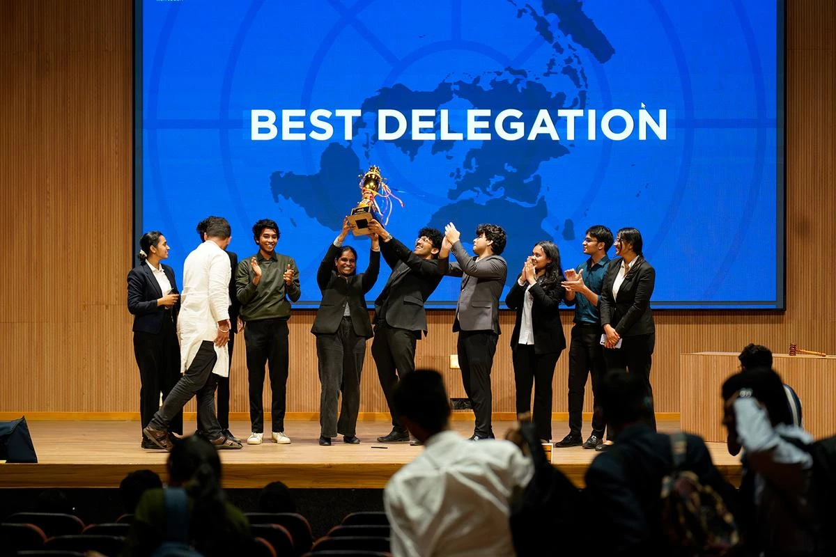 A delegation lifting the Best Delegation trophy on stage